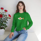 Woman wearing a green sweatshirt with a fish design, sitting next to a potted plant with red flowers.