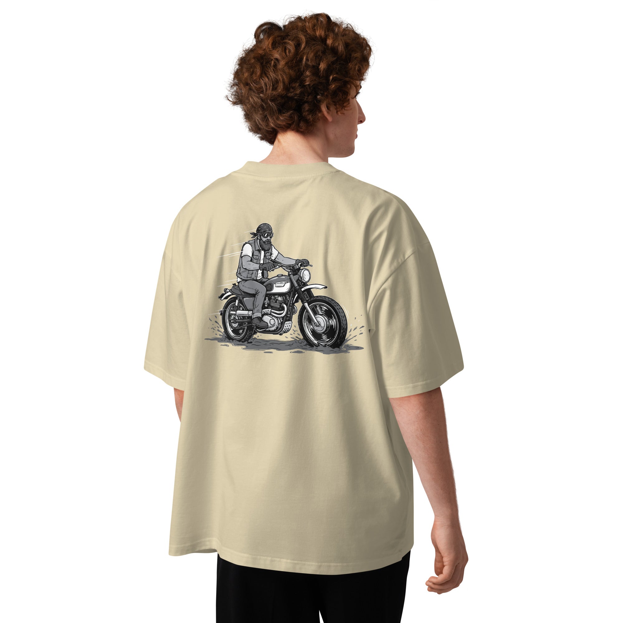 Person wearing a beige t-shirt with a graphic of a person on a motorcycle on the back.