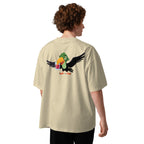 Person wearing a beige t-shirt with a colorful parrot design on the back, standing against a white background.