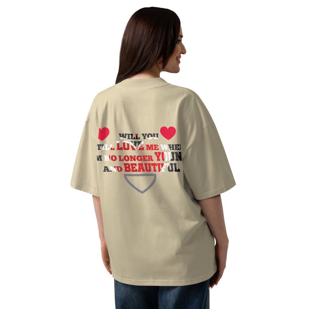 Person wearing a beige t-shirt with text and heart graphics on the back