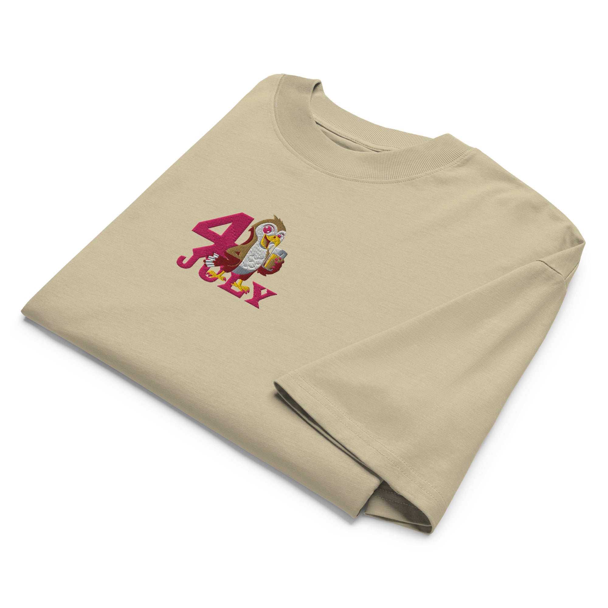 Folded beige t-shirt with 4th of July design on a white background