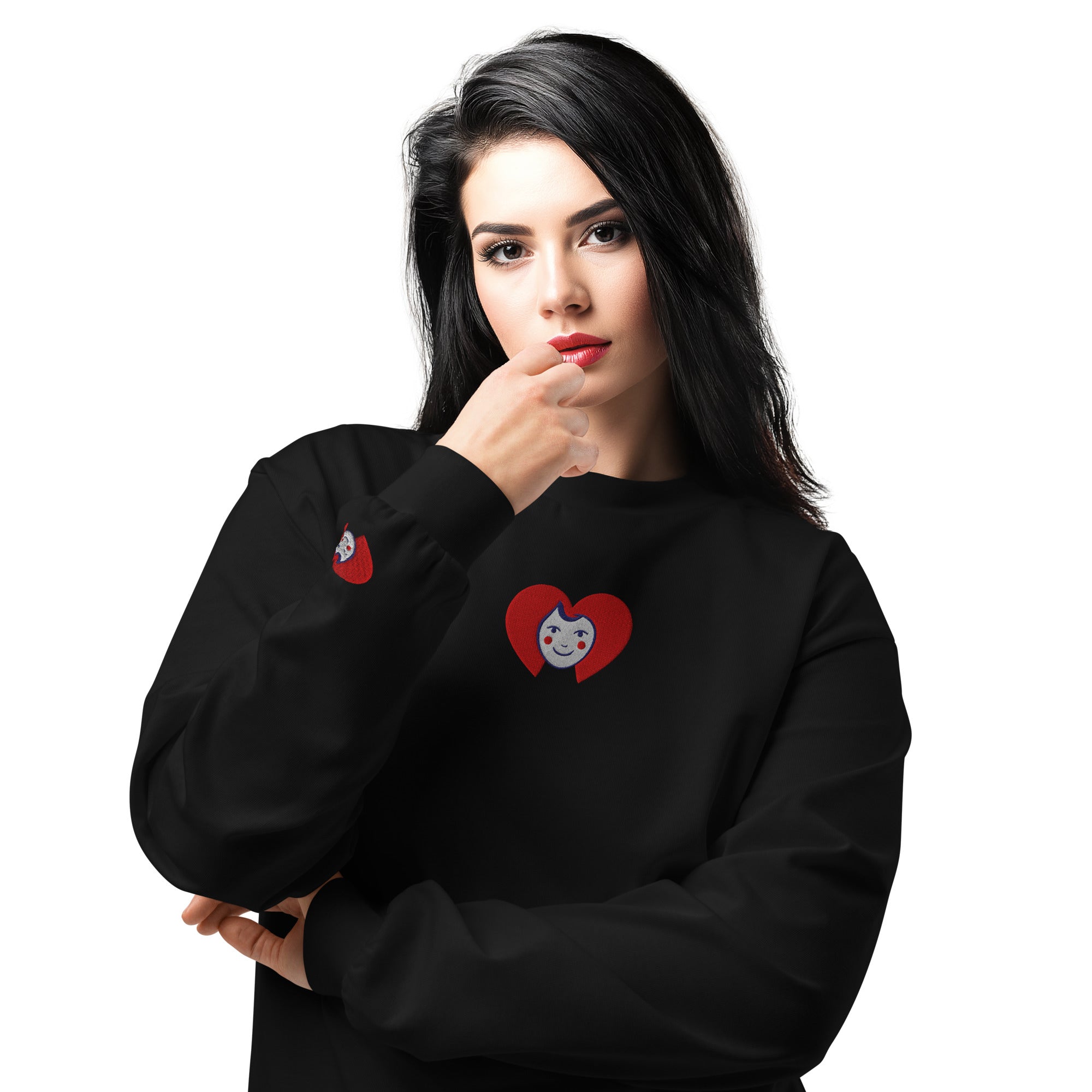 Woman wearing a black sweatshirt with red heart designs on a white background