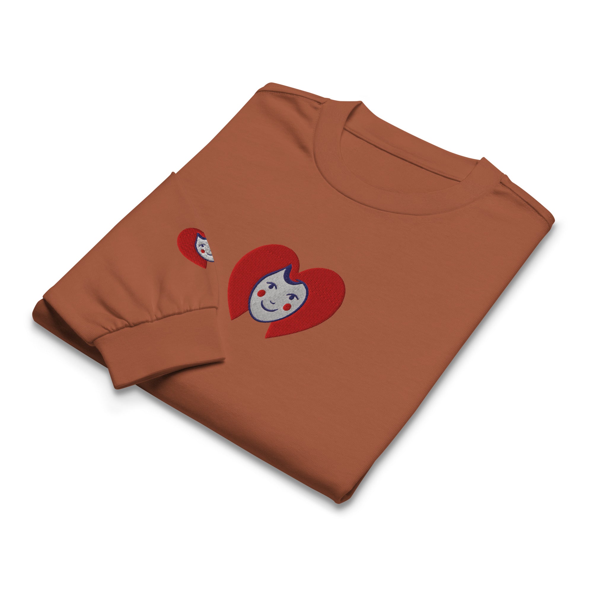 Folded brown t-shirt with cartoon character design on a white background