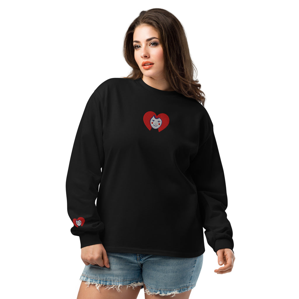 Woman wearing a black long-sleeve shirt with a red heart design on a white background