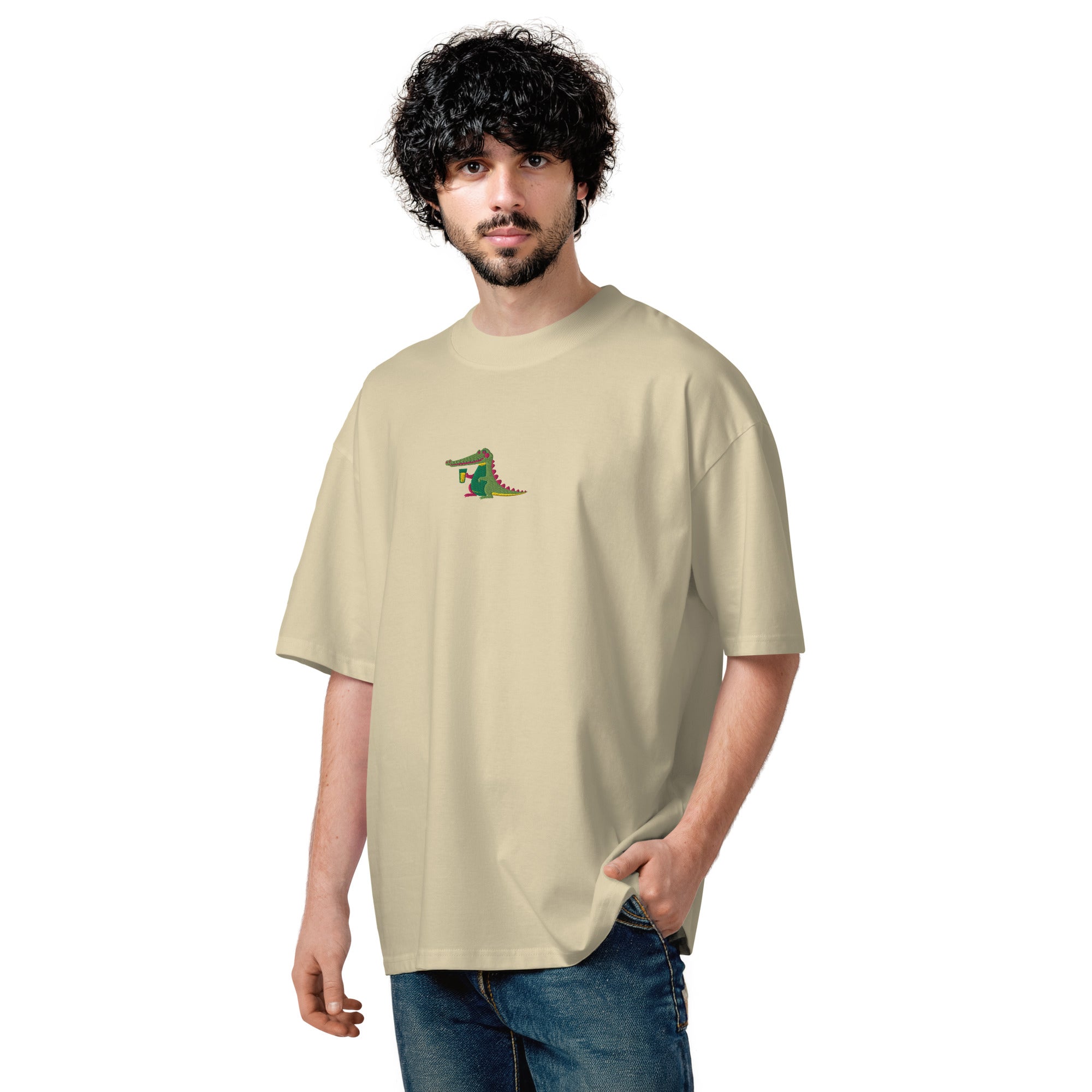 Man wearing a beige t-shirt with a logo on a white background