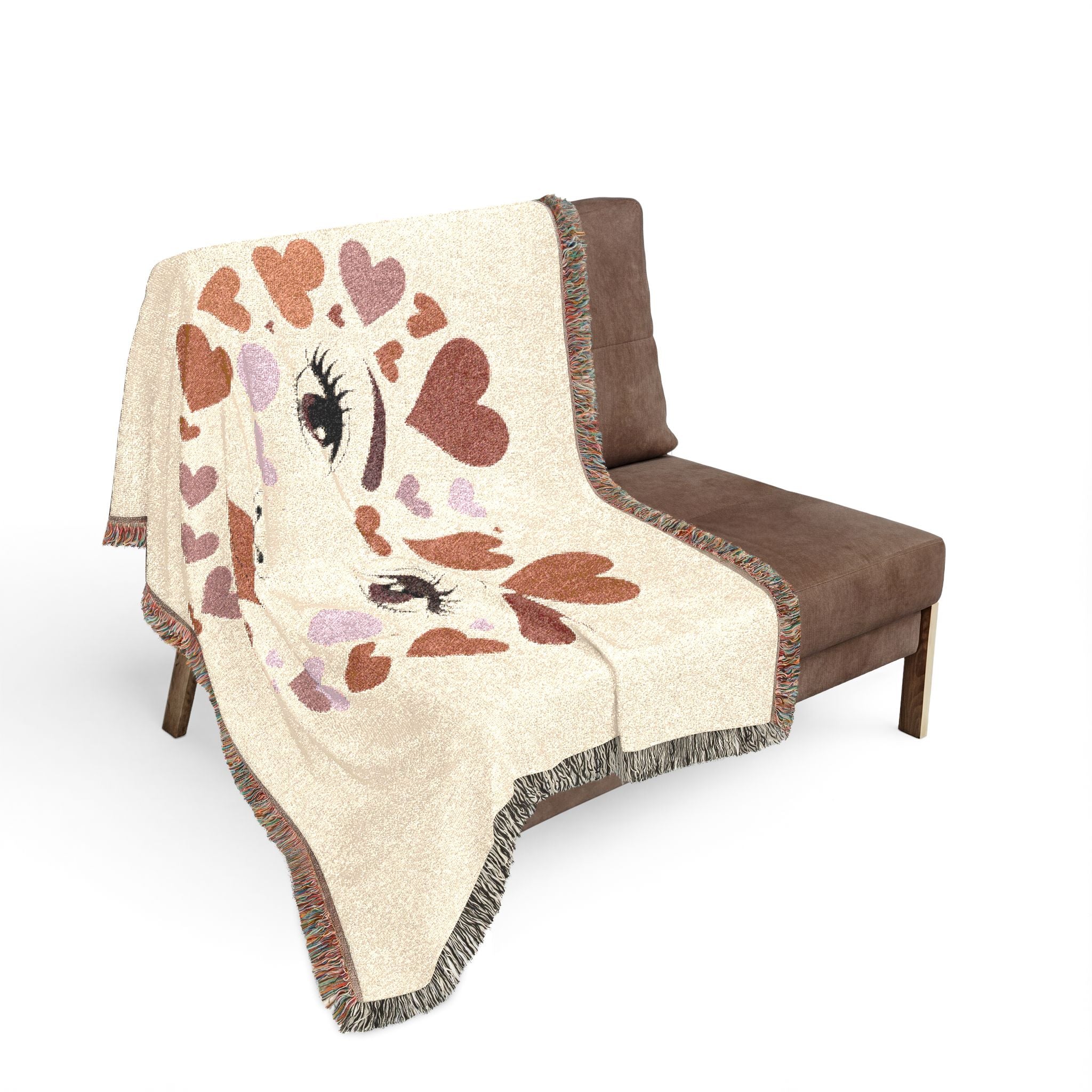 Blanket with heart and eye design draped over a brown chair on a white background