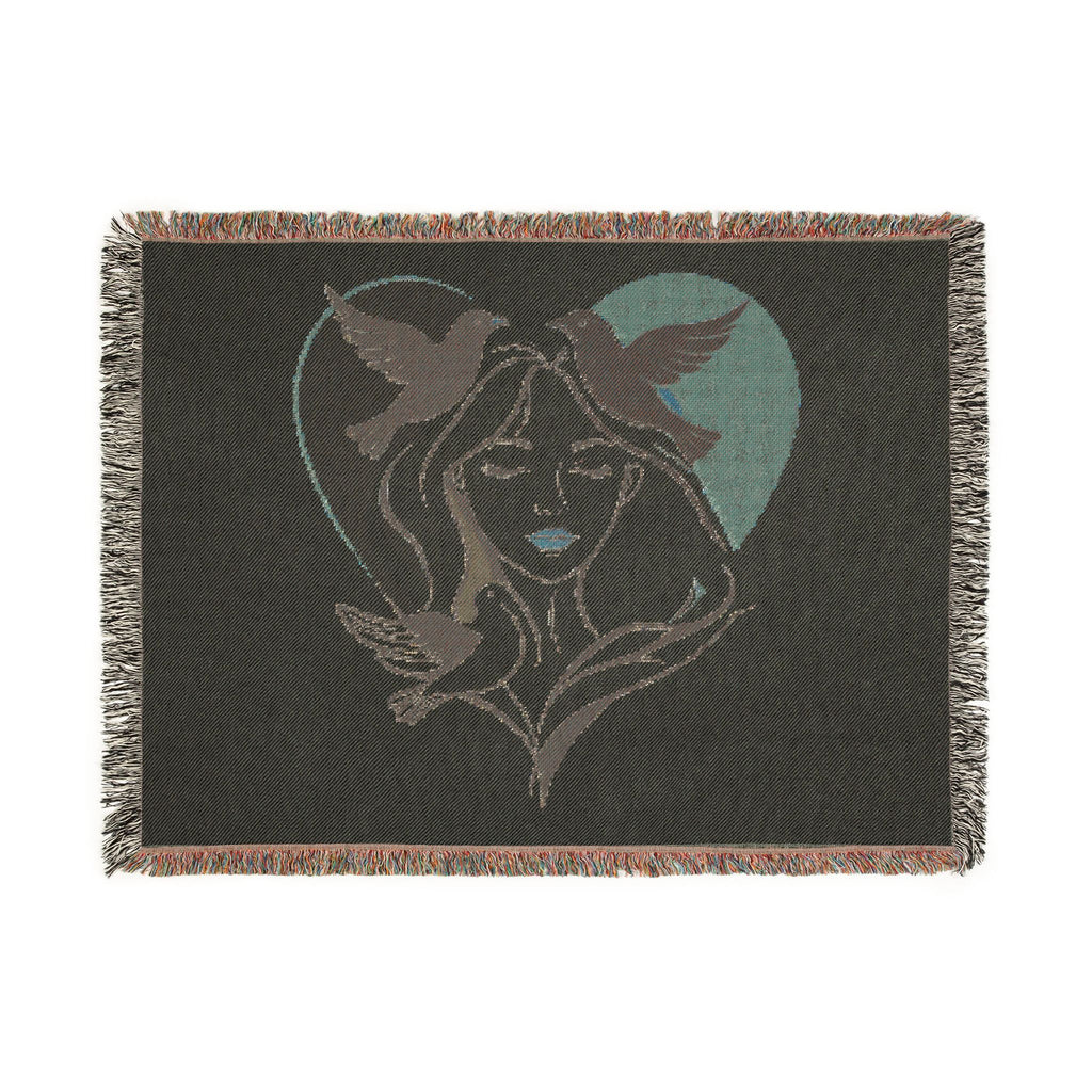 Blanket with a design of a woman's face and birds in a heart shape on a dark background