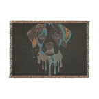 Blanket with a stylized dog face design on a black background